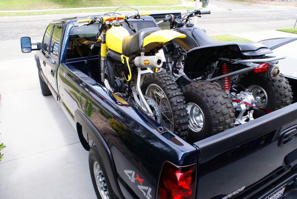 dirt bike and quad in truck bed